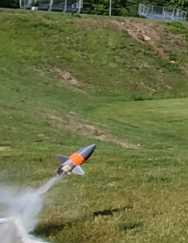 Gray bottle rocket blasts off